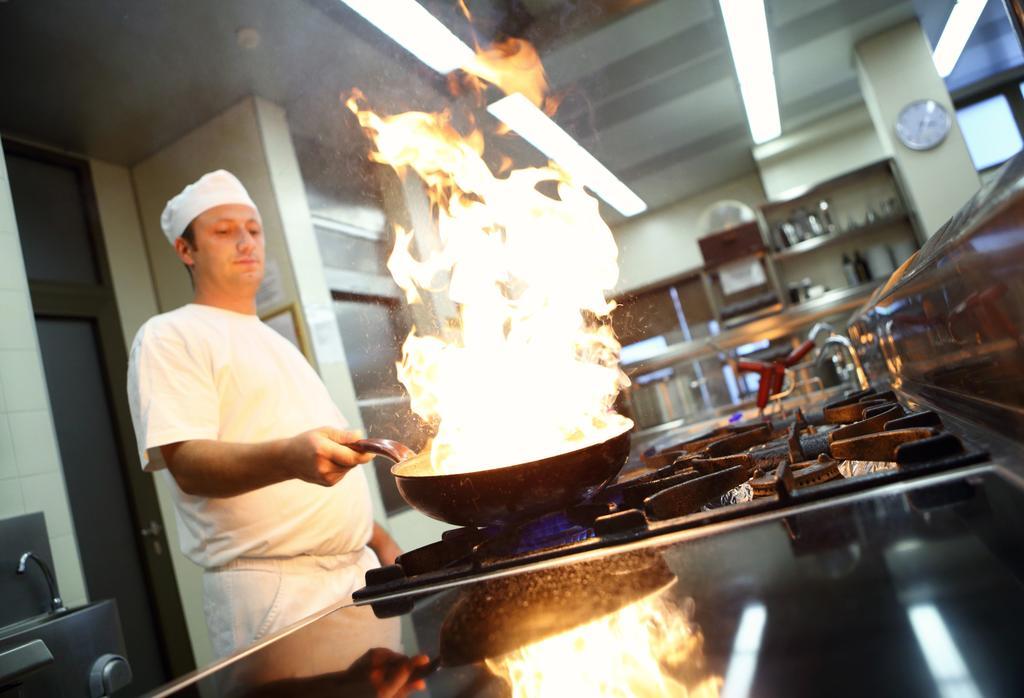 Hotel Premier Aqua - Adults Only Vrdnik Luaran gambar A chef cooking with a wok